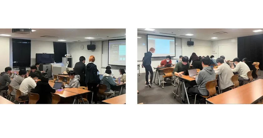 複数の人々が教室やワークショップ会場のような場所で、それぞれノートパソコンを使って作業している様子